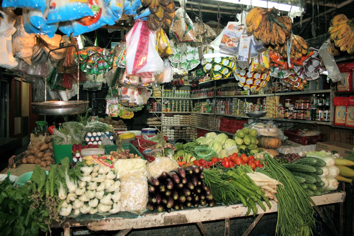 Fresh vegetables and market baskets at an Asian market stall