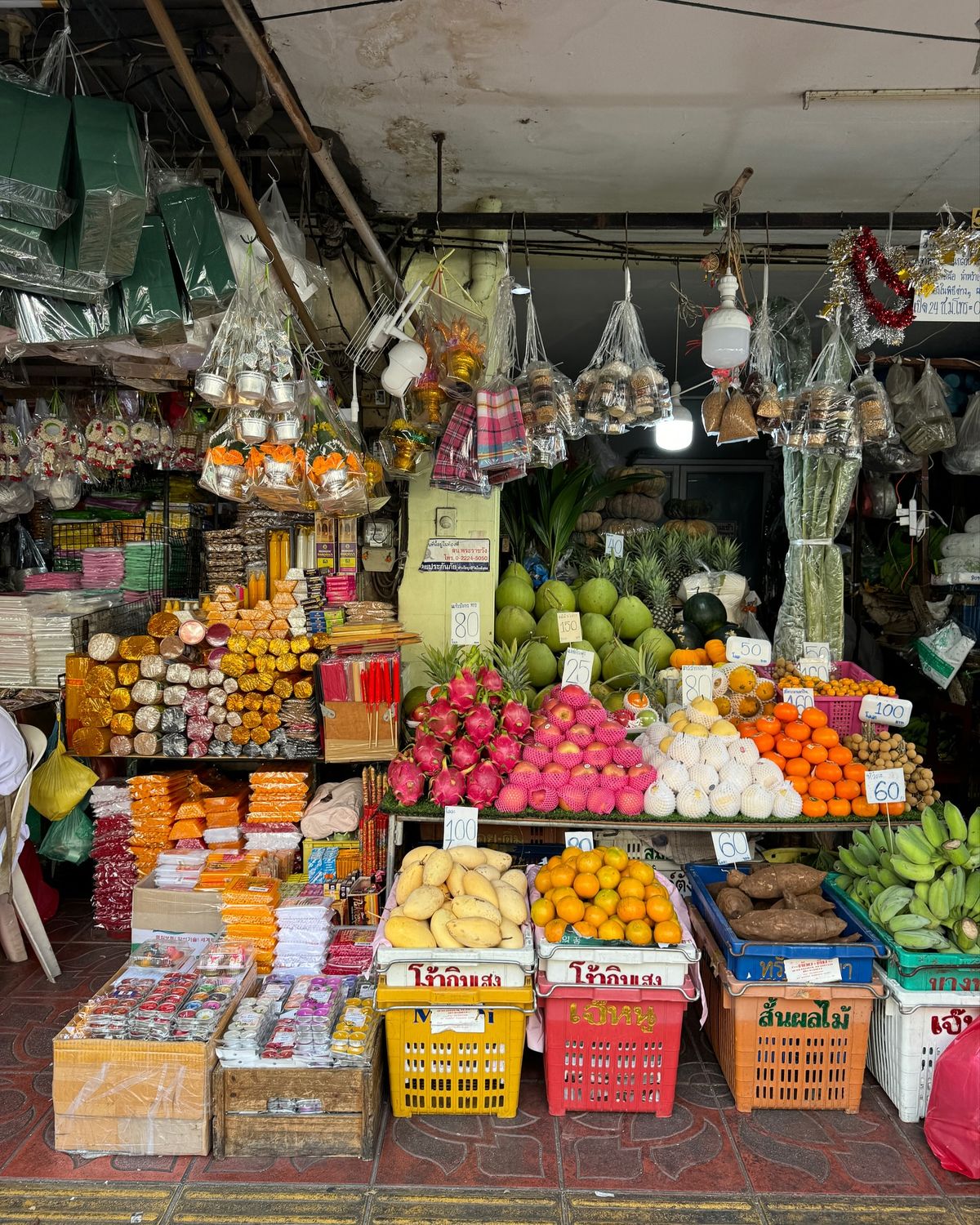 Produce and packaged goods stacked in a market stall